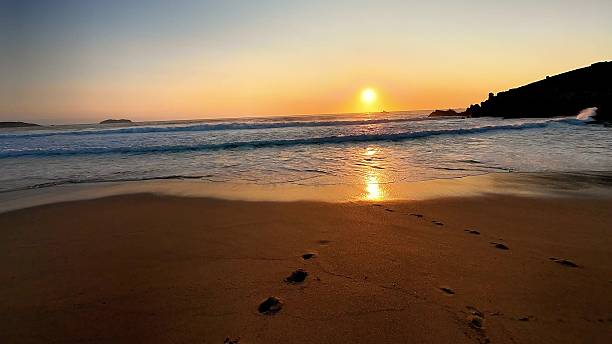 istock A tranquil and serene beach sunset scene, adorned with footprints gracefully imprinted in the sand 2213430064