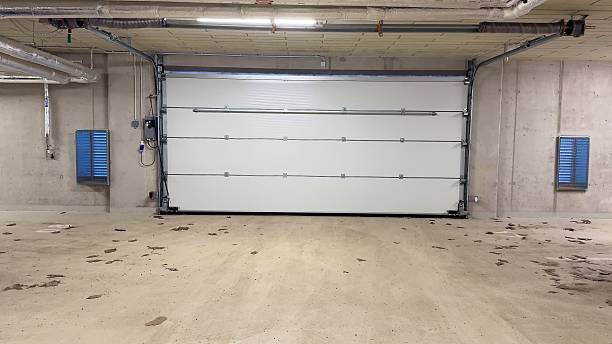 istock This is a spacious garage interior showcasing a modern white door that enhances its appeal 2213430532