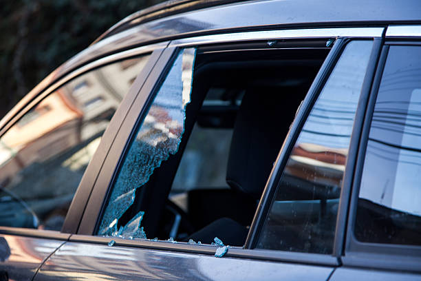 istock Thief broken glass in car window 2213430987