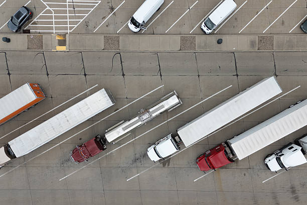 istock Several trucks parked tightly in a busy parking lot, creating a crowded and industrious scene. 2213432985