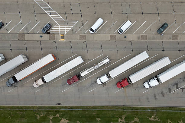 istock Trucks parked in a vast lot, orderly rows under the sun. 2213432999