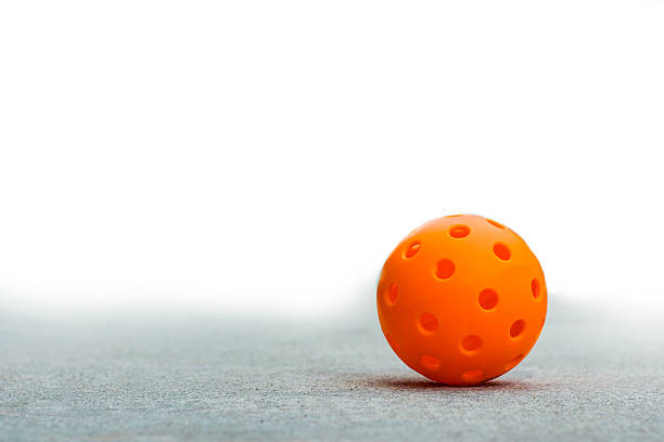 istock Orange Pickleball on a blank white background 2213433568