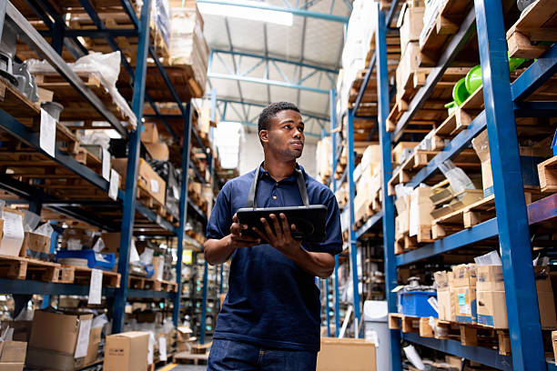 istock Warehouse worker taking inventory of the merchandise using a digital tablet 2213436386