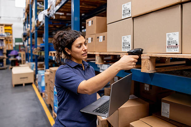 istock Warehouse worker scanning codes while taking inventory of the merchandise 2213436439