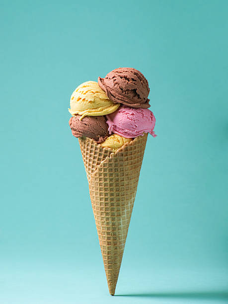 istock A waffle cone overflows with three scoops of delicious ice cream: chocolate, strawberry, and vanilla 2213439033