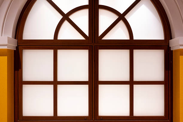 istock Close up of a yellow wall with arched windows 2213439738
