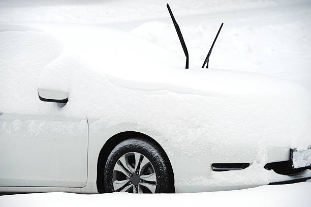 istock car covered by snow in blizzard 2213440782