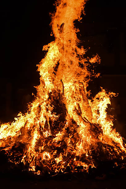 istock Fire flames on black background, Blaze fire flame texture background, Beautifully, the fire is burning, Fire flames with wood and cow dung bonfire 2213445026