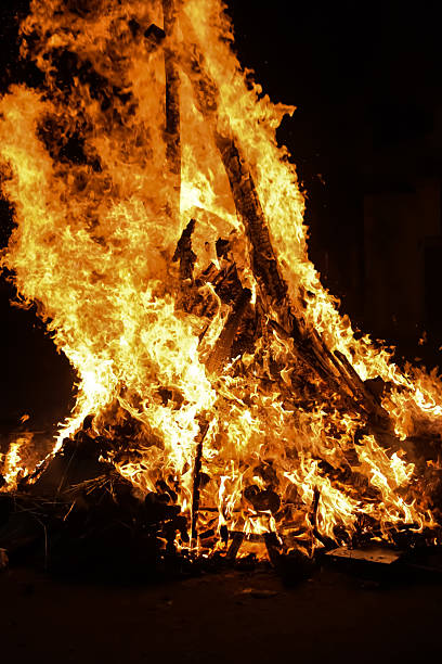 istock Fire flames on black background, Blaze fire flame texture background, Beautifully, the fire is burning, Fire flames with wood and cow dung bonfire 2213445031