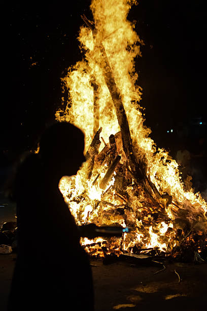 istock Fire flames on black background, Blaze fire flame texture background, Beautifully, the fire is burning, Fire flames with wood and cow dung bonfire 2213445038