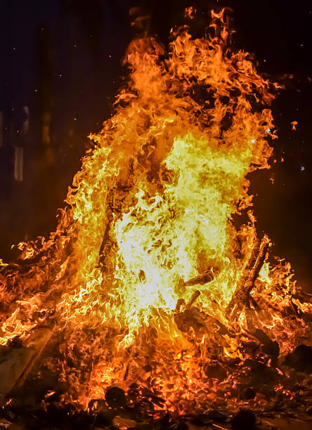 istock Fire flames on black background, Blaze fire flame texture background, Beautifully, the fire is burning, Fire flames with wood and cow dung bonfire 2213445058
