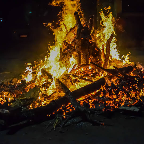 istock Fire flames on black background, Blaze fire flame texture background, Beautifully, the fire is burning, Fire flames with wood and cow dung bonfire 2213445065