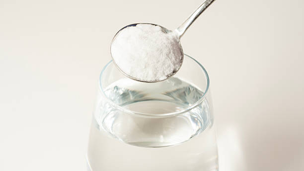 istock Adding baking soda to a glass of water 2213445272