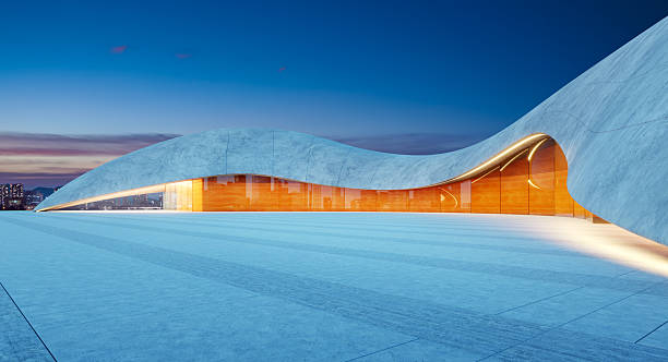 Perspective view of empty concrete floor with modern futuristic building exterior at twilight