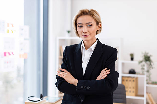 istock Confident businesswoman standing at desk in modern office workspace 2213452146