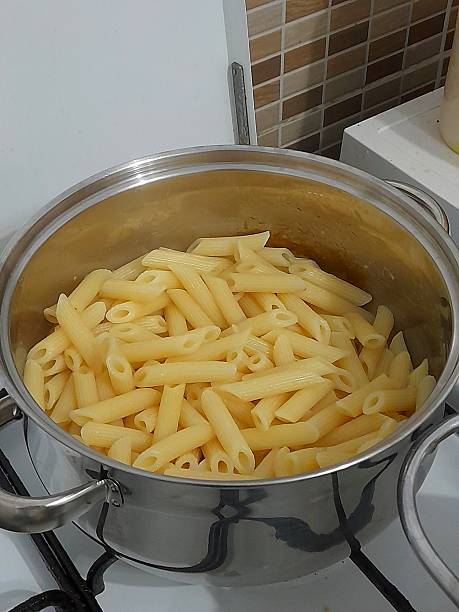 Cooked pasta in cooking pan in the kitchen.