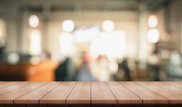 istock Empty wooden table top with lights bokeh on blur restaurant background. 2213457307