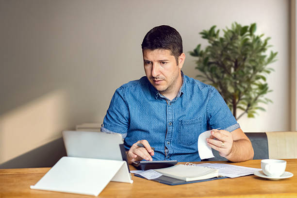 istock Mature man working in doing taxes online 2213457439