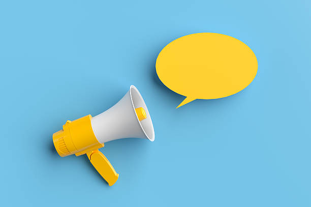 istock Megaphone making an announcement with speech bubble on blue background 2213458502