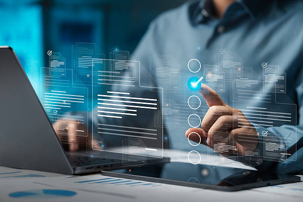 istock Businessman doing online survey to fill out digital document form for business performance review, document management concept, online document database and digital filing system or software. 2213458715