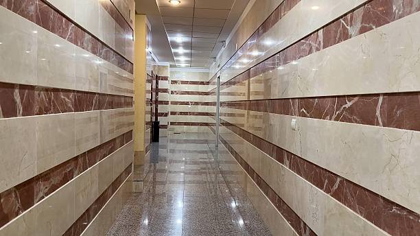 A sleek and modern hallway featuring chic marble wall designs that are perfect for various types of commercial spaces