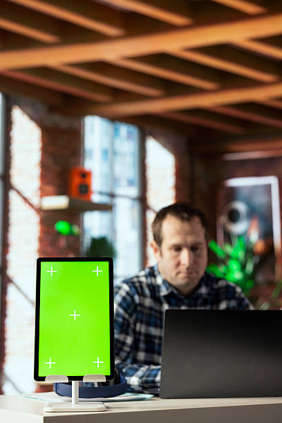 istock Close up of isolated screen tablet used by worker in home office analyzing data charts 2213459795