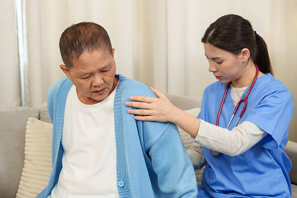 istock Physiotherapist carefully examines elderly patient's shoulder, offering gentle assistance and personalized care to improve mobility and reduce discomfort. 2213459889