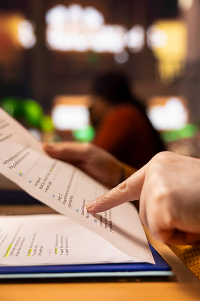 istock Senior pupil in a study area surrounded by library books and paperwork, 2213459957