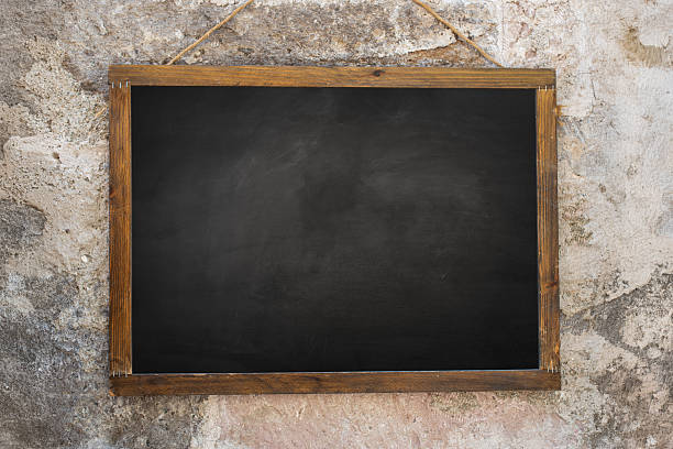 istock Blank blackboard with wooden frame on concrete wall. 2213462131