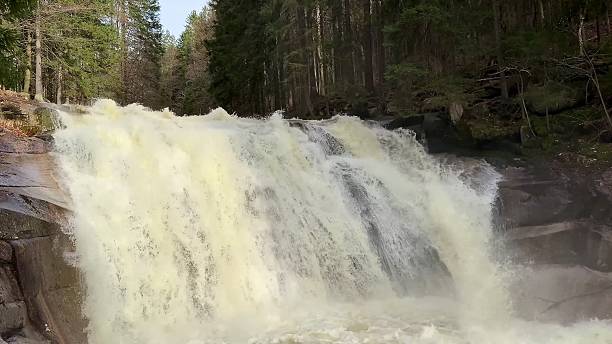 istock Experience the Majestic Waterfall Flowing Gracefully Through a Beautiful Lush Forest Landscape 2213462146