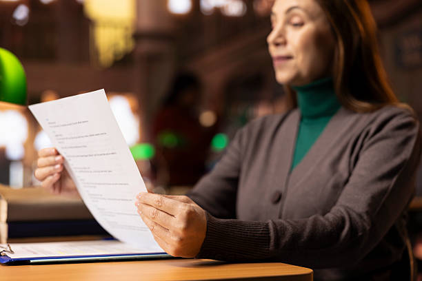 istock Aged focused woman in a public library studying educational materials 2213462427