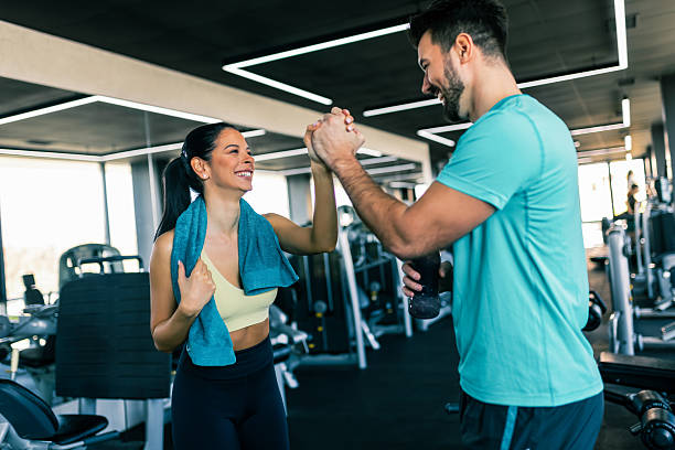 istock Two fit people high five after good workout in the gym. 2213462743