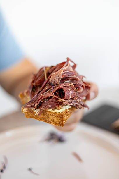 Large pastrami sandwich piled high with meat. Excessive Pastrami Sandwich