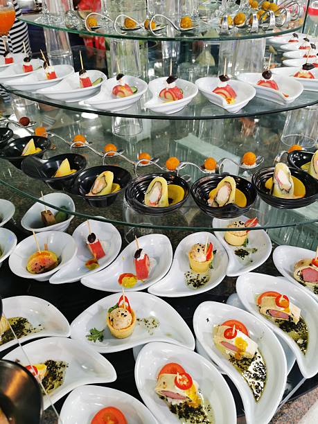 A beautifully arranged festive table with fresh watermelon slices, various fruits, and beverages, creating a lively and inviting atmosphere perfect for a relaxed gathering or celebration in a warm setting.