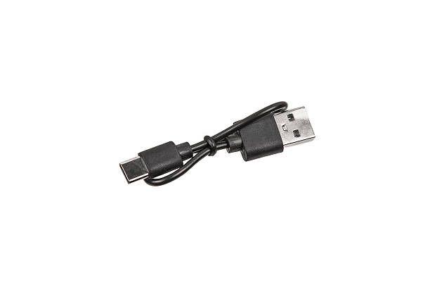 istock Black USB cable with two connectors, neatly coiled and secured with a strap, isolated on a white background, showcasing its practicality and modern design. 2213463857