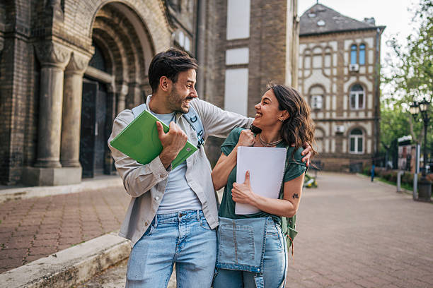 istock Two happy students leaving university after passing exams 2213463972