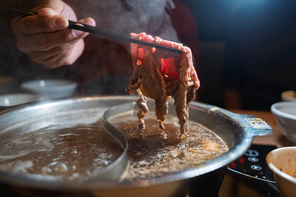 Cooking Sliced Beef Meat in Sukiyaki Hot Pot