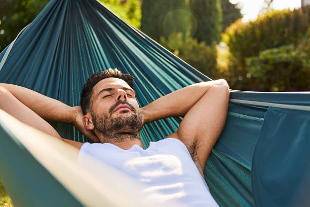 istock Handsome man sleeping in hammock in the backyard 2213464585