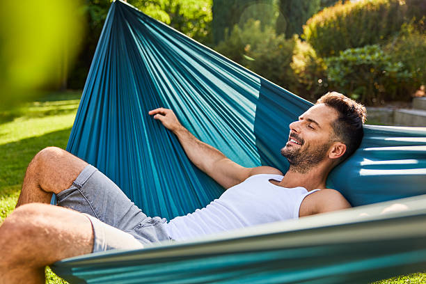 istock Adult man resting in hammock during summer afternoon in backyard 2213464705