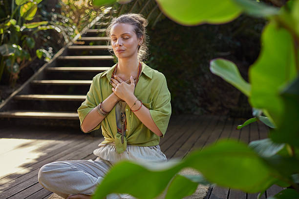 Young beautiful woman meditating in retreat