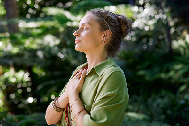 istock Woman practicing meditation with a feeling of gratitude and peace 2213465356