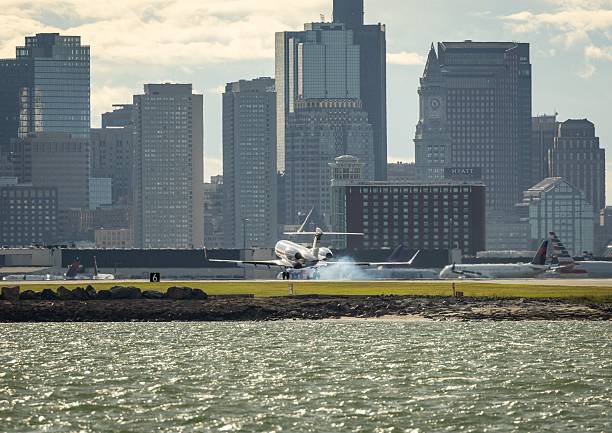 istock Airplane landing with city skyline backdrop. 2213466489