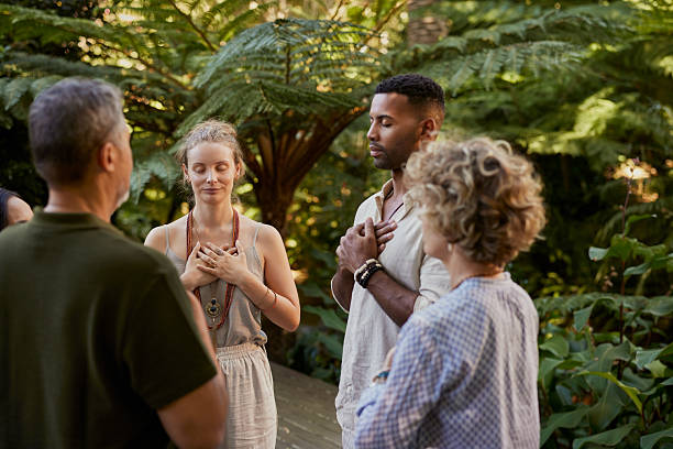 istock People meditating at holistic retreat with hands on heart 2213466825