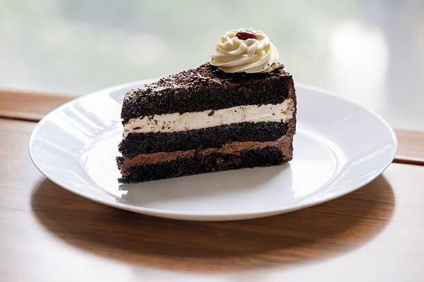 istock Chocolate cake slice with cream and cherry topping 2213466853
