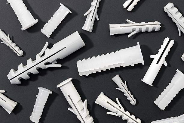 Plastic wall plug for fastener screw on white background.