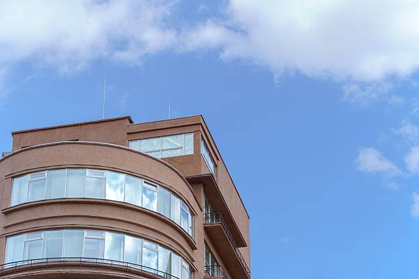 istock Tall brown building with a blue sky in the background 2213469027