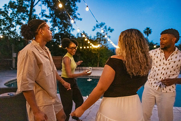 istock Friends dancing and having fun at after party on poolside 2213469262