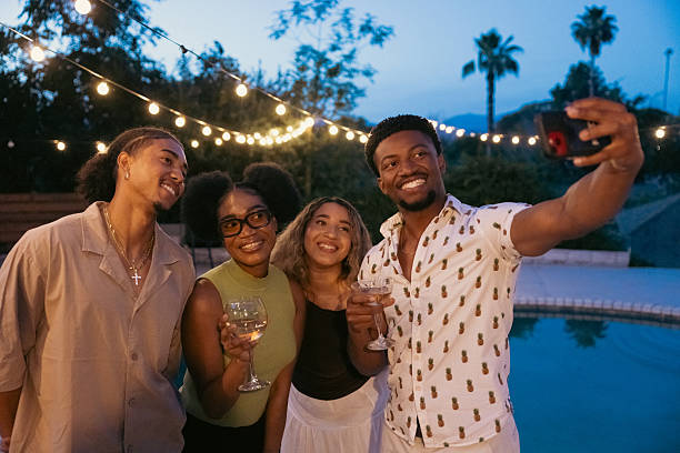 istock Friends having fun at after party on poolside 2213469419