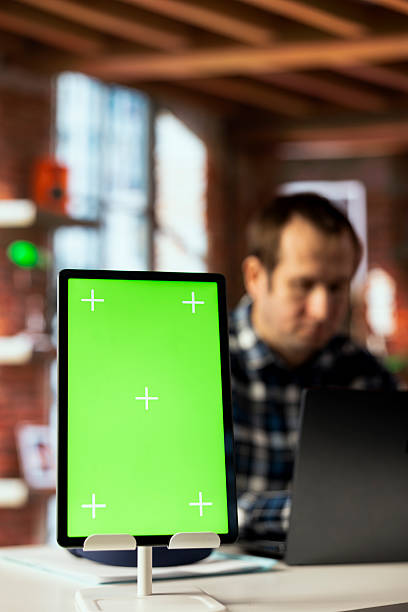 istock Focus on green screen tablet used by employee checking emails 2213469647