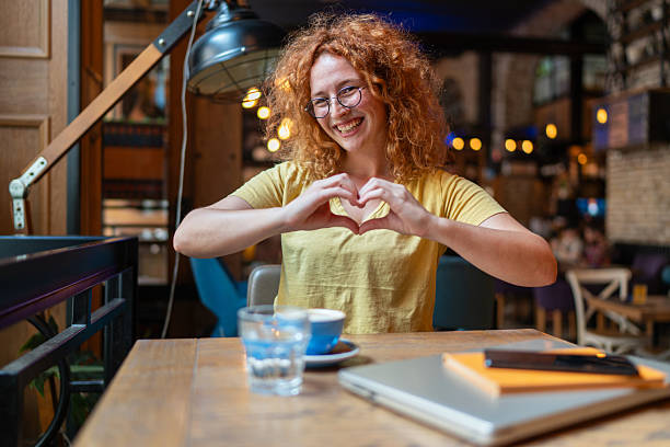 istock Freelancer showing heart sign with hands in cafe 2213469684